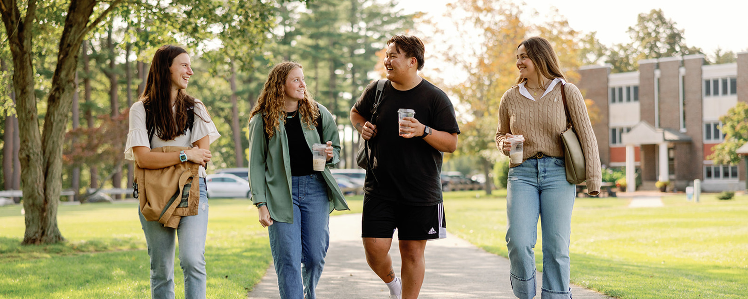 students walking with coffee