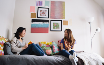 two female students casually talking while sitting in a dorm room at Gordon College, a top Christian college in New England