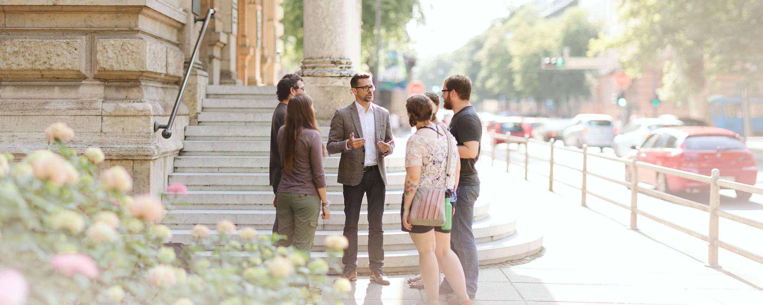 professor speaking to students outside historic building in Croatia