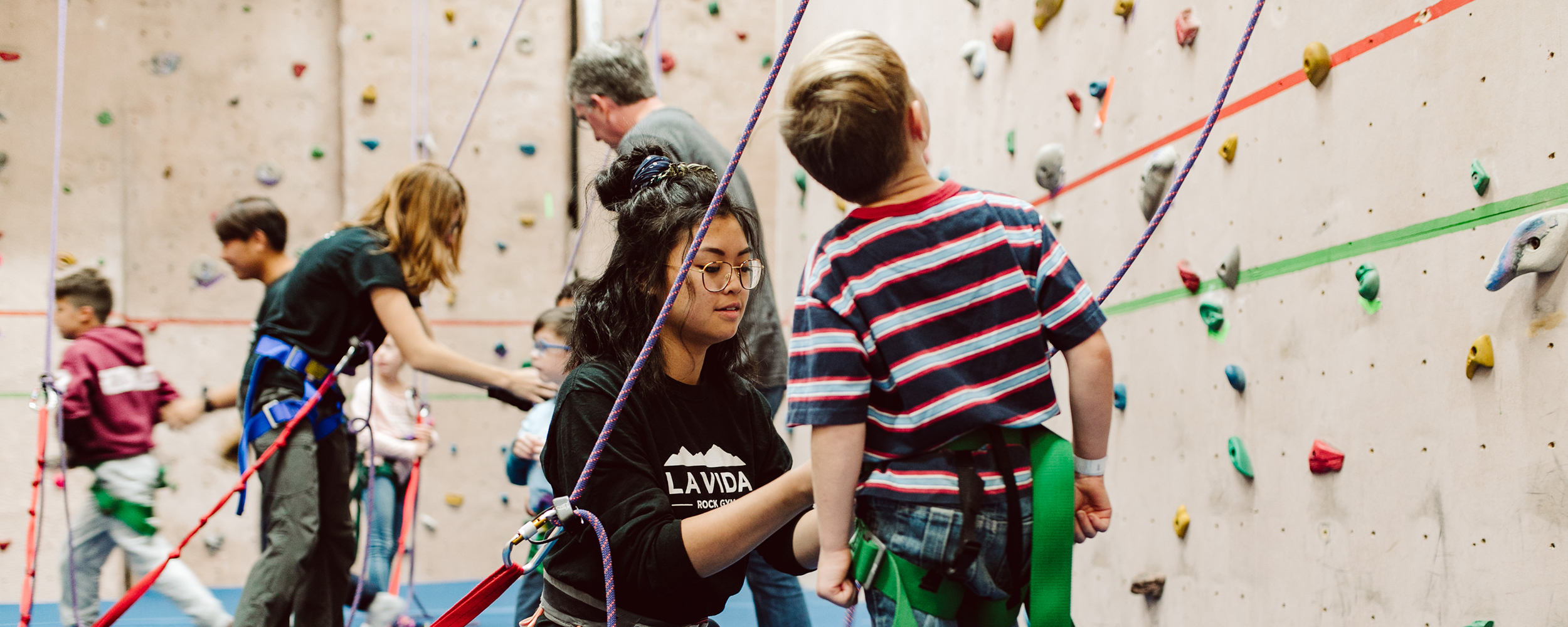 Kid climbing at Gordon College Rock Gym. 