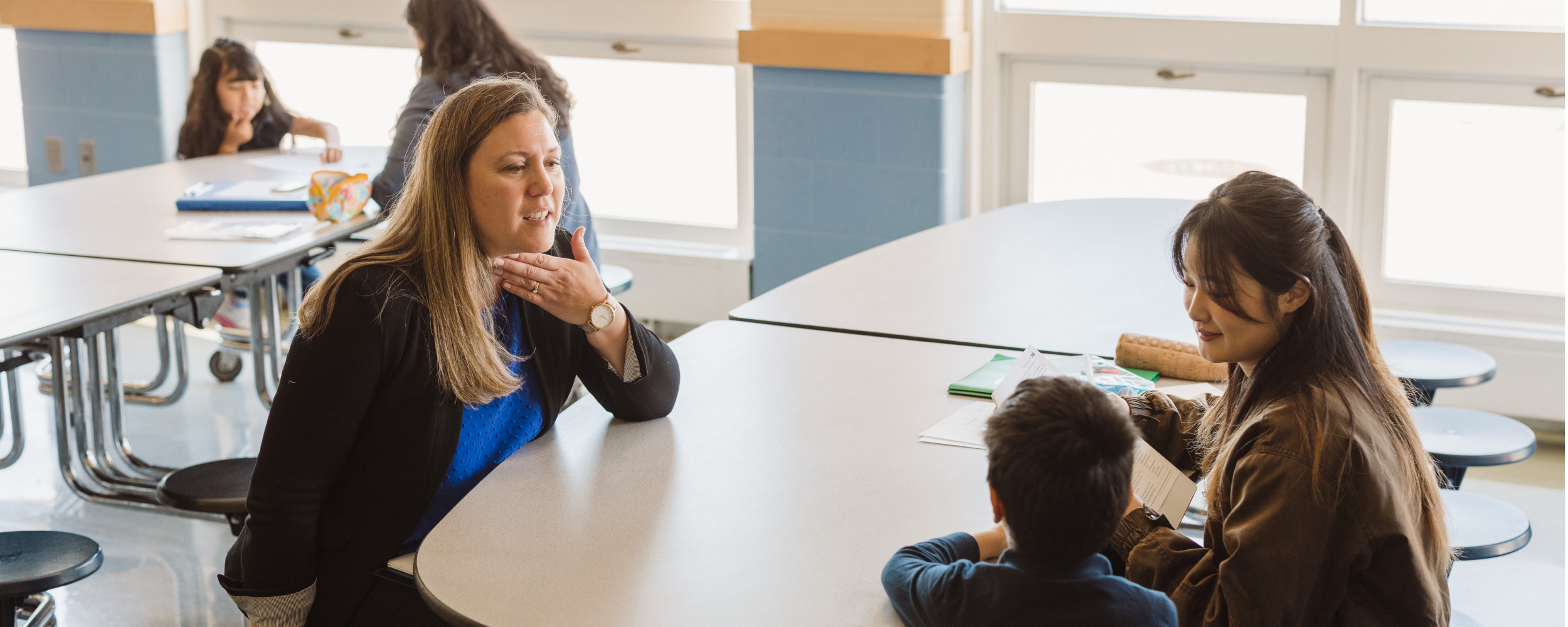 Teacher at table with students