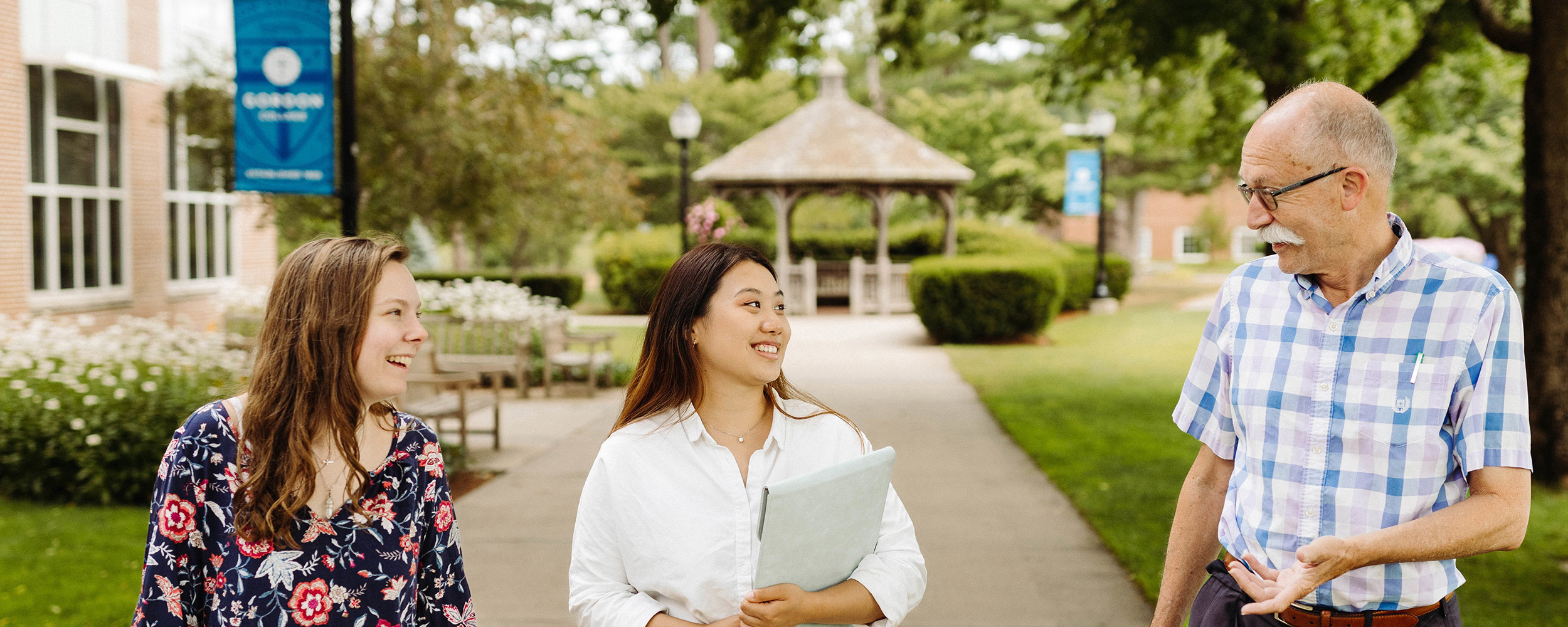 students walking with professor on Gordons campus