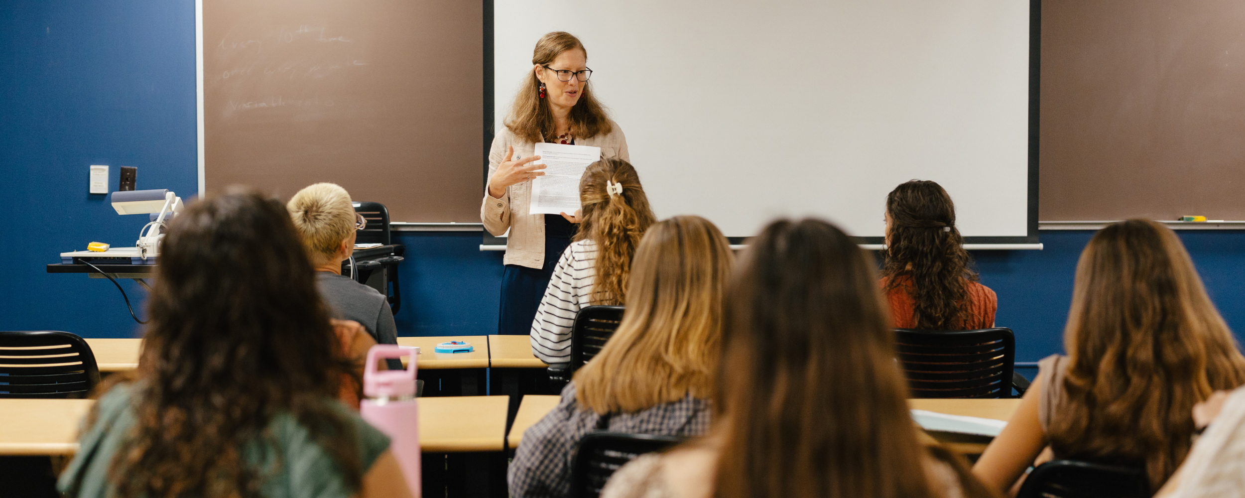 Teacher instructing classroom of students