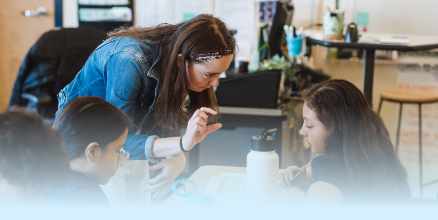 a student of Gordon College’s Master’s in education program working at an elementary school with students.