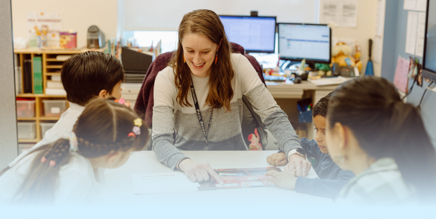 a student of Gordon College’s Master’s in education program working at an elementary school with students.