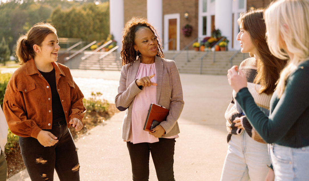 education professor in group conversation with students